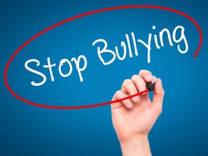 52873356 - man hand writing stop bullying with black marker on visual screen. isolated on blue. business, technology, internet concept. stock photo