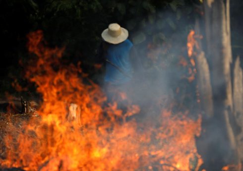 A man works in a burning tract of Amazon jungle as it is being cleared by loggers and farmers in Iranduba, Amazonas state, Brazil August 20, 2019. REUTERS/Bruno Kelly