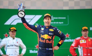 Formula One F1 - Chinese Grand Prix - Shanghai International Circuit, Shanghai, China - April 15, 2018 Red Bull's Daniel Ricciardo celebrates with a trophy on the podium after winning the race as Mercedes' Valtteri Bottas and Ferrari's Kimi Raikkonen look on REUTERS/Aly Song TPX IMAGES OF THE DAY