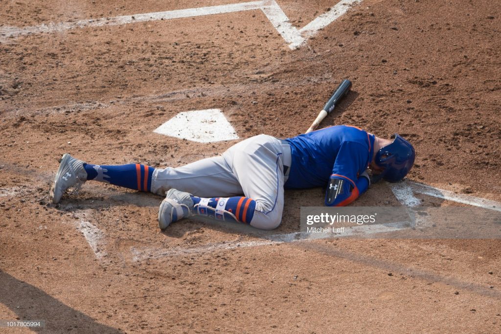 PHILADELPHIA, PA - AUGUST 16: Brandon Nimmo #9 of the New York Mets lays on the ground after in injury in the top of the third inning against the Philadelphia Phillies in game one of the doubleheader at Citizens Bank Park on August 16, 2018 in Philadelphia, Pennsylvania. (Photo by Mitchell Leff/Getty Images)