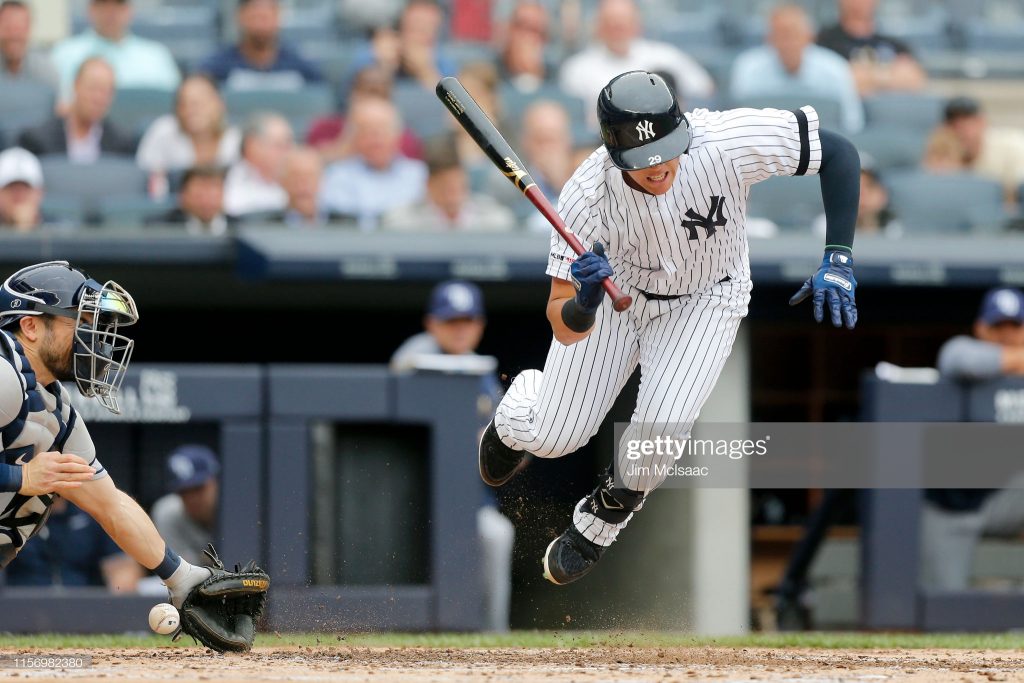 NEW YORK, NEW YORK - JUNE 19: Gio Urshela #29 of the New York Yankees is hit by a pitch with the bases loaded during the first inning against the Tampa Bay Rays at Yankee Stadium on June 19, 2019 in New York City. (Photo by Jim McIsaac/Getty Images)