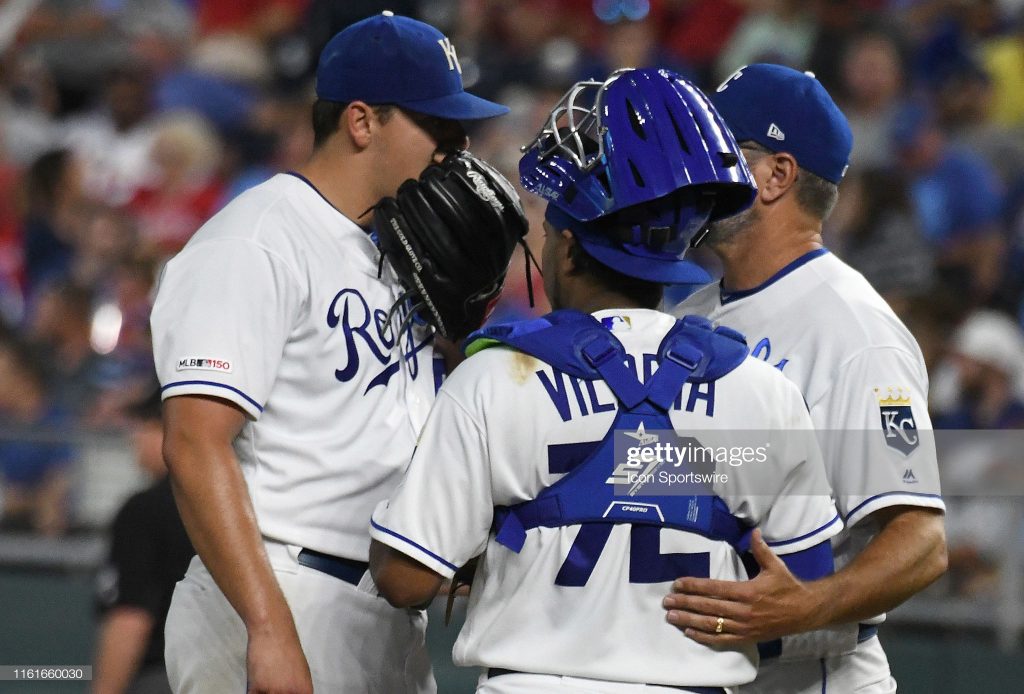 KANSAS CITY, MO. - AUGUST 14: Kansas City Royals catcher Meibrys Viloria (72) and Royals pitching coach Cal Eldred talk to Kansas City Royals starting pitcher Brad Keller (56) during a time out during a Major League Baseball game between the St. Louis Cardinals and the Kansas City Royals on August 14, 2019, at Kauffman Stadium, Kansas City, MO. (Photo by Keith Gillett/Icon Sportswire via Getty Images)