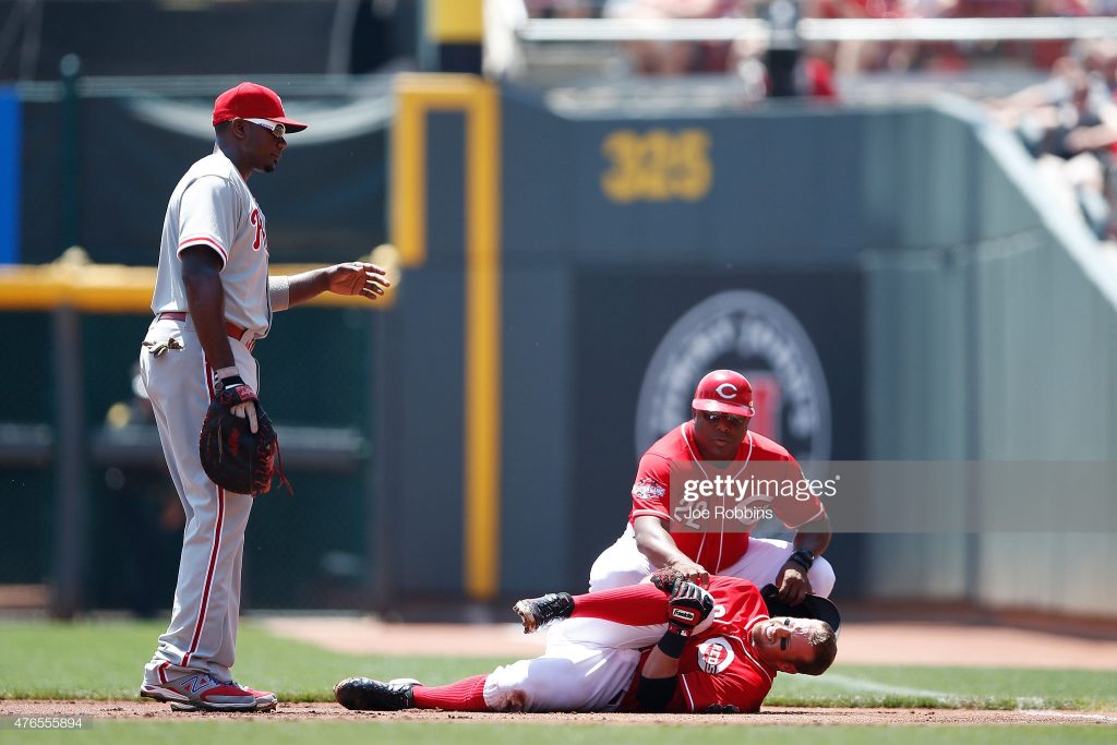 CINCINNATI, OH - JUNE 10: Zack Cozart #2 of the Cincinnati Reds holds his knee after suffering an injury on a play at first base in the first inning against the Philadelphia Phillies at Great American Ball Park on June 10, 2015 in Cincinnati, Ohio. (Photo by Joe Robbins/Getty Images)