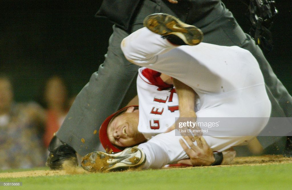 ANAHEIM, CA - MAY 8: Darin Erstad #17 of the Anaheim Angels holds his hamstring after injuring himself while sliding into home plate during the third inning against the Tampa Bay Devil Rays on May 8, 2004 at Angel Stadium in Anaheim, California. (Photo by Lisa Blumenfeld/Getty Images)