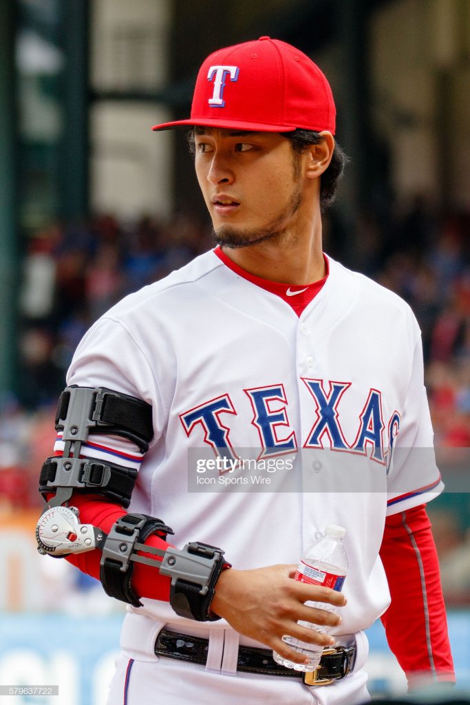 10 APR 2015: During the home opener between the Houston Astros and the Texas Rangers, Rangers Pitcher Yu Darvish (11) wears an arm brace after under going Tommy John surgery earlier this Spring. Houston defeats Texas 5-1. (Photo by Andrew Dieb/Icon Sportswire/Corbis/Icon Sportswire via Getty Images)