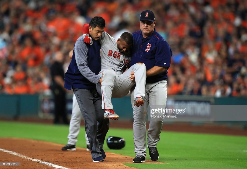 HOUSTON, TX - OCTOBER 05: Eduardo Nunez #36 of the Boston Red Sox is carried off the field by Red Sox trainer Masai Takahashi and manager John Farrell after suffering an injury in the first inning against the Houston Astros during game one of the American League Division Series at Minute Maid Park on October 5, 2017 in Houston, Texas. (Photo by Ronald Martinez/Getty Images)