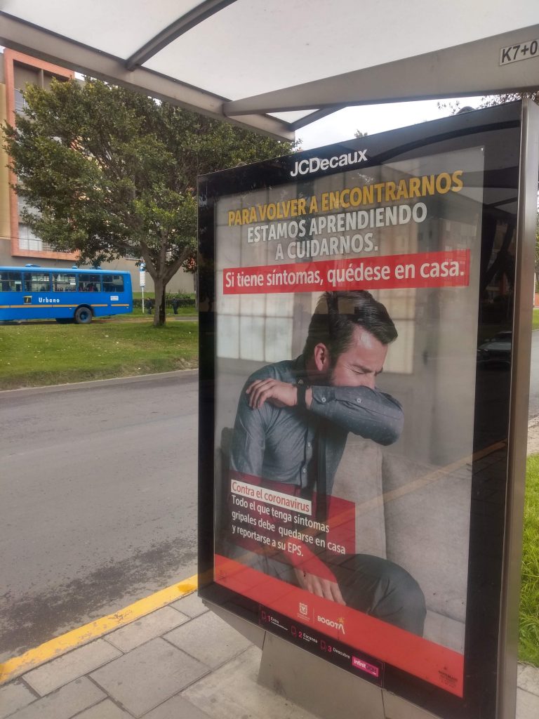 A bus-stop poster warns about Covid-19 symptoms in Bogotá, Colombia.