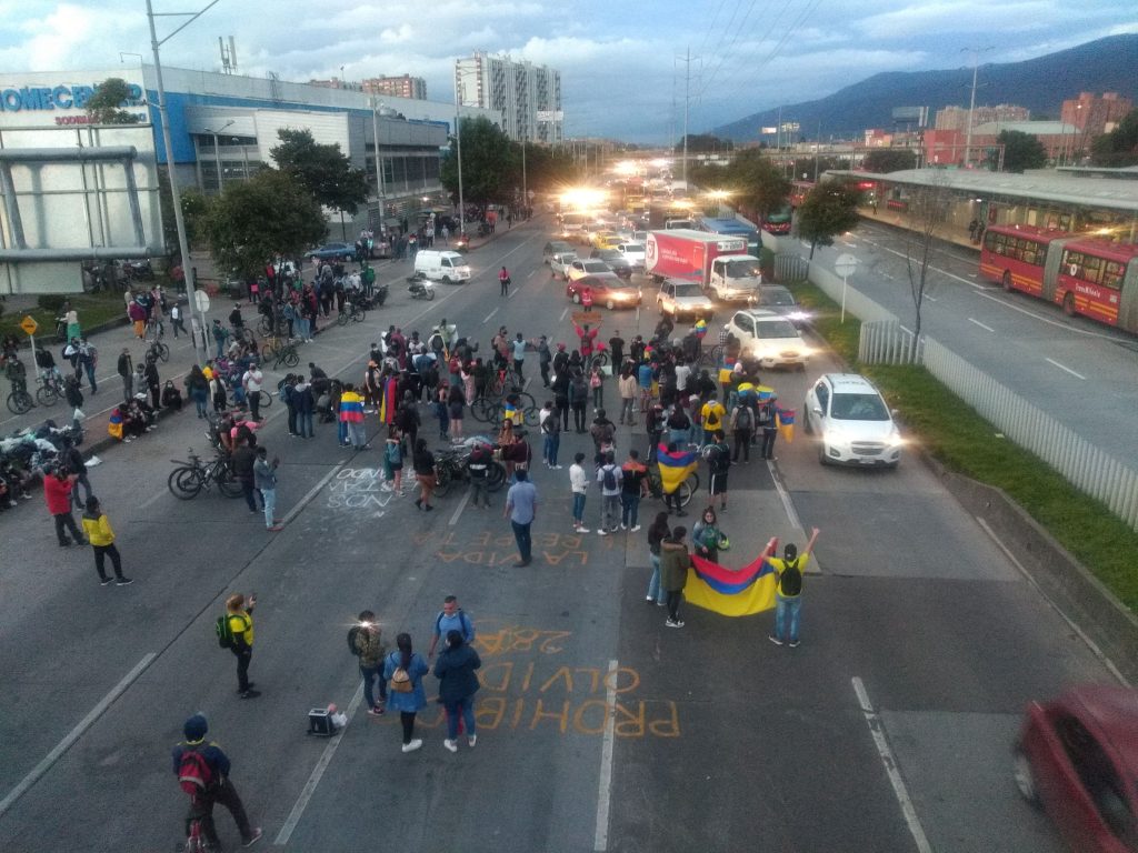 Rather than a post-pandemic boom, many of us can expect the hard times to get worse. Image shows protesters blocking one of Bogotá's main arteries in the north of the city. 