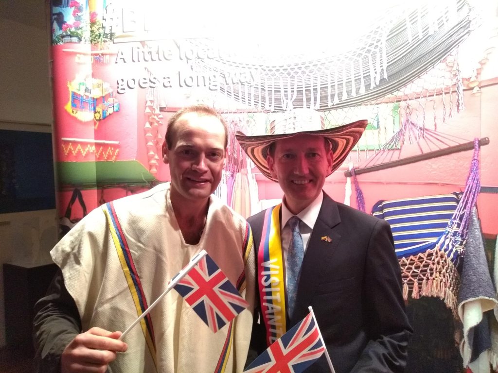 Wrong Way Corrigan "proudly" waves the Union Jack with the UK's ambassador to Colombia, Colin Martin-Reynolds.